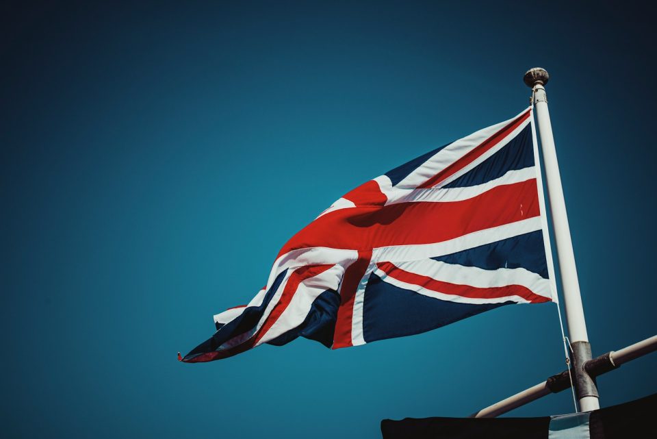 uk flag on pole under blue sky during daytime